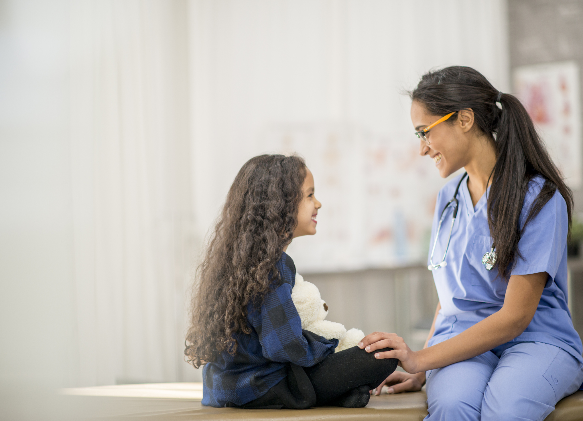 nurse sitting with child patient
