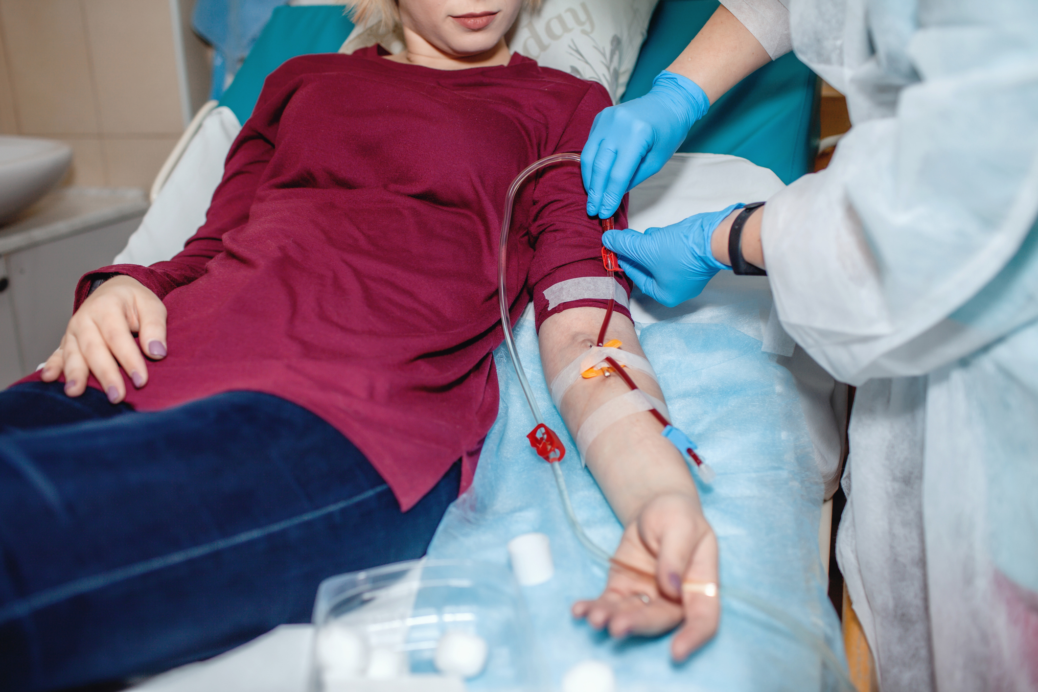 nurse fixing patient dialysis blood tubing