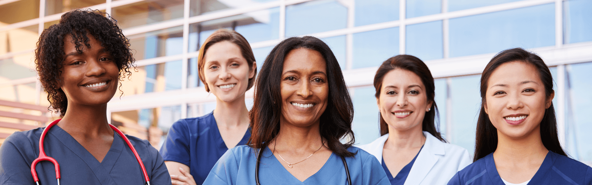 Five nurses standing together outside